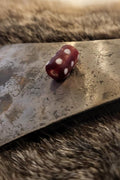 Early medieval cylindrical red glass bead with white dots