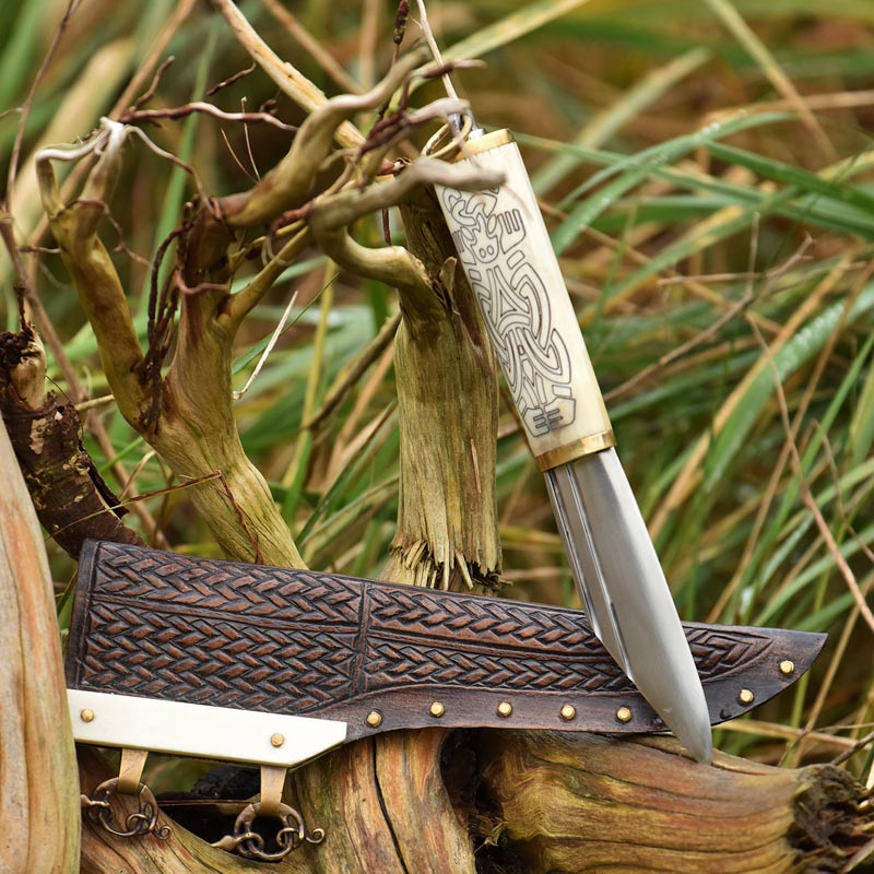 Small Viking seax knife with ornate bone handle in Borre style and leather sheath