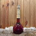 Cranberry wine in elixir bottle