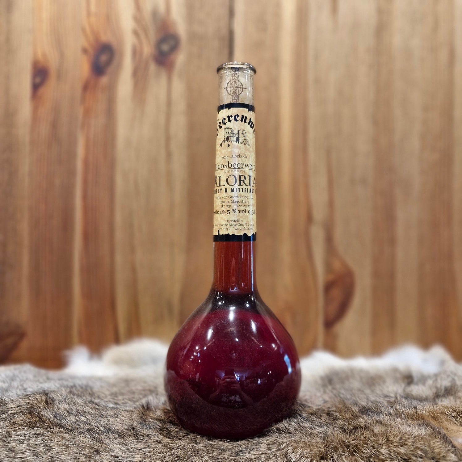 Moosbeerwein in Elixierflasche
