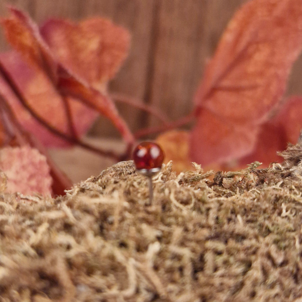 Silver stud earrings with amber sphere