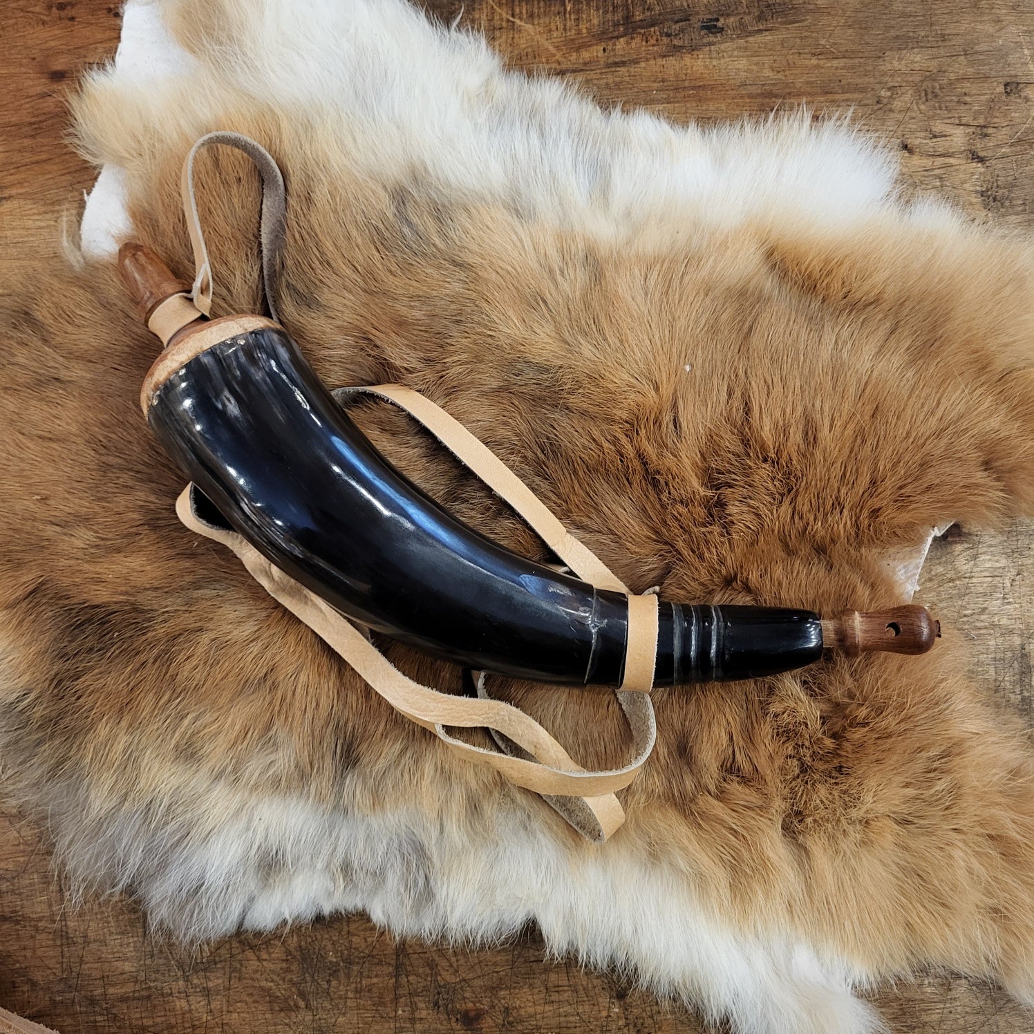 Powder horn with leather strap and wooden stopper