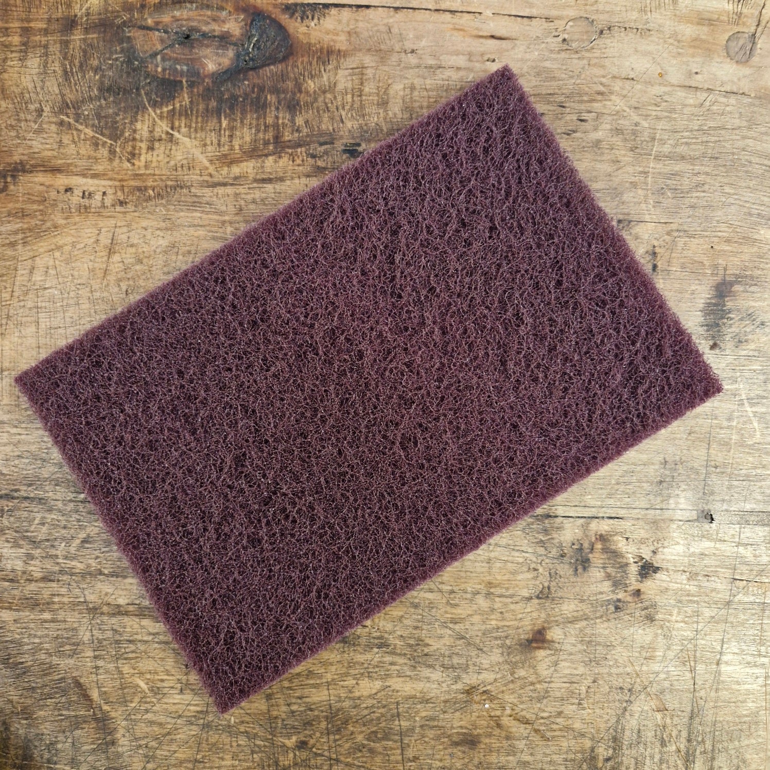 Abrasive fleece for cleaning weapons and armor