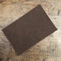 Abrasive fleece for cleaning weapons and armor
