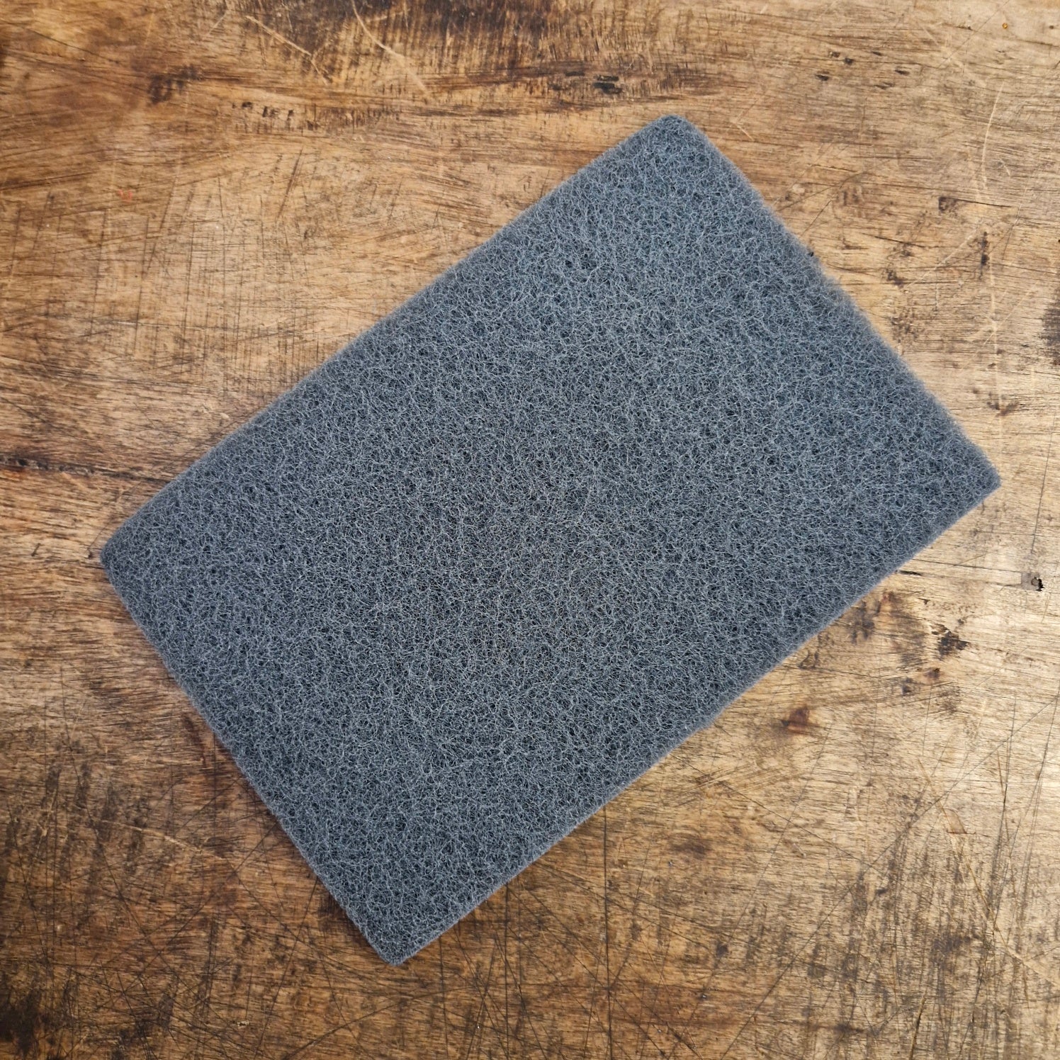 Abrasive fleece for cleaning weapons and armor