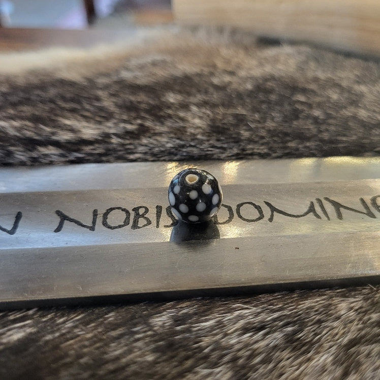 Medieval black glass bead with white dots