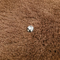 Black spherical bead with white thread pattern made of glass