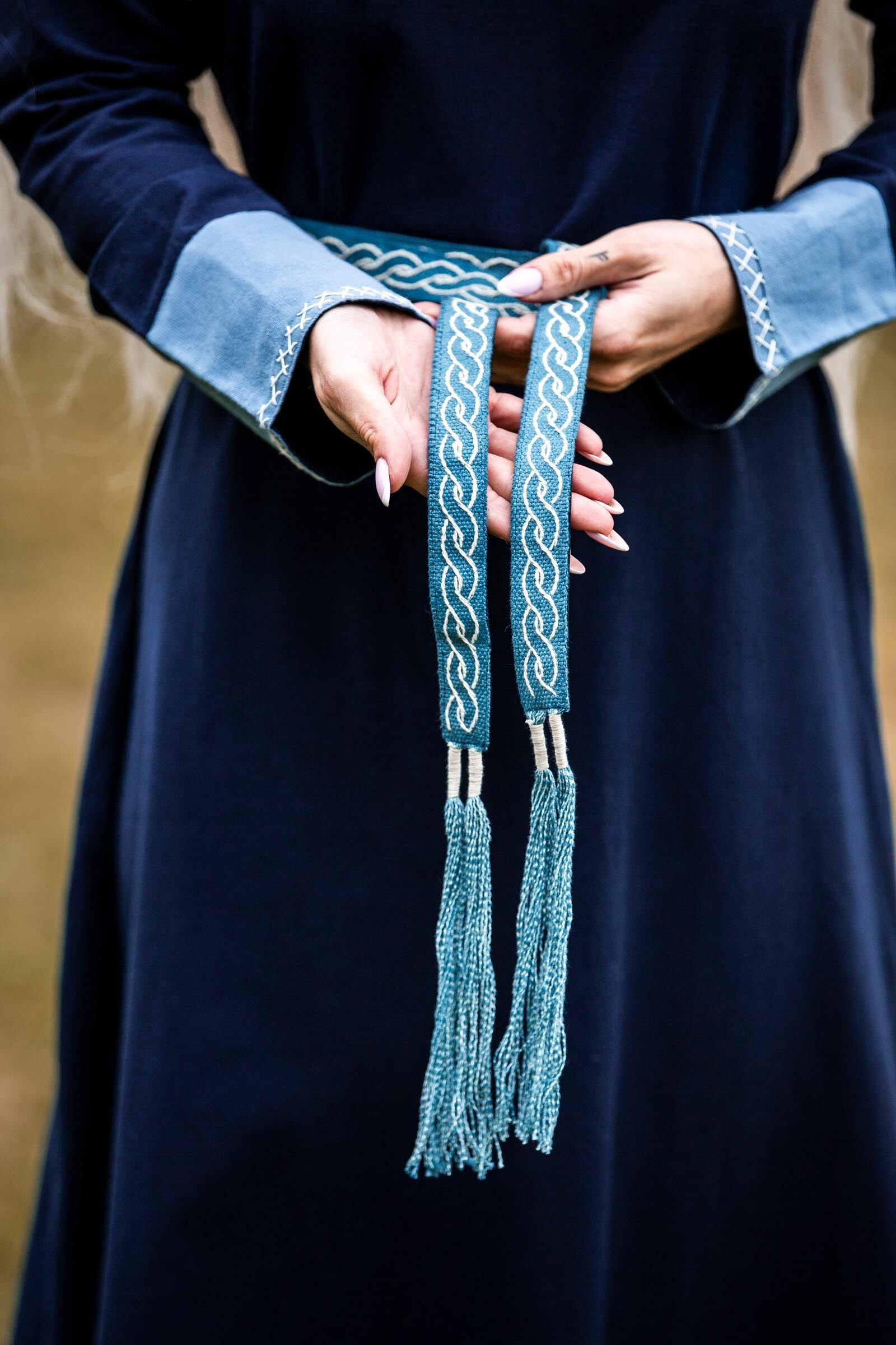 Narrow early medieval fabric belt with embroidery