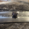 Barrel bead dark blue with orange/white thread pattern